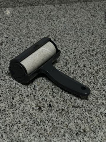 Phone photo: the lint roller on a granite worktop