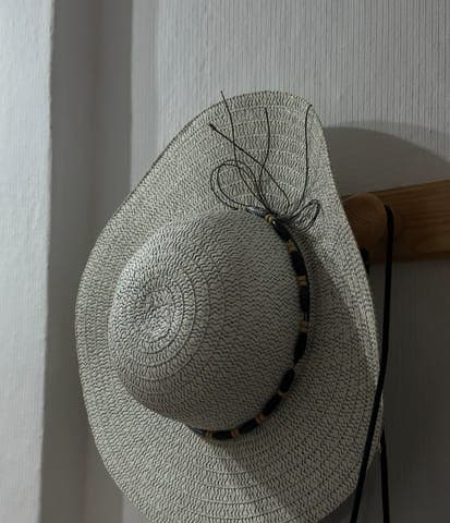 Phone photo: the hat on a wooden peg